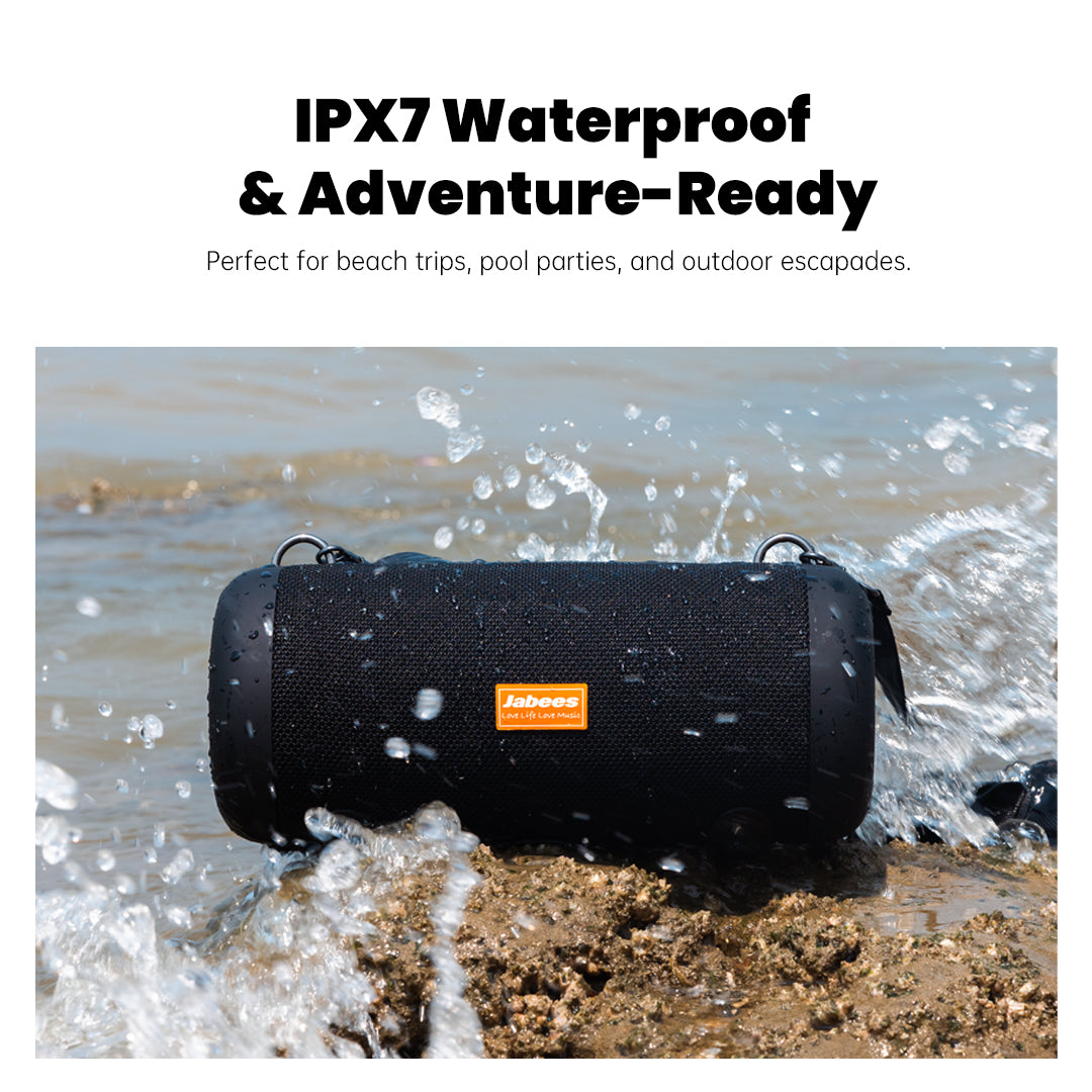 Black waterproof speaker on a rock with water splashing, featuring Jackery logo.