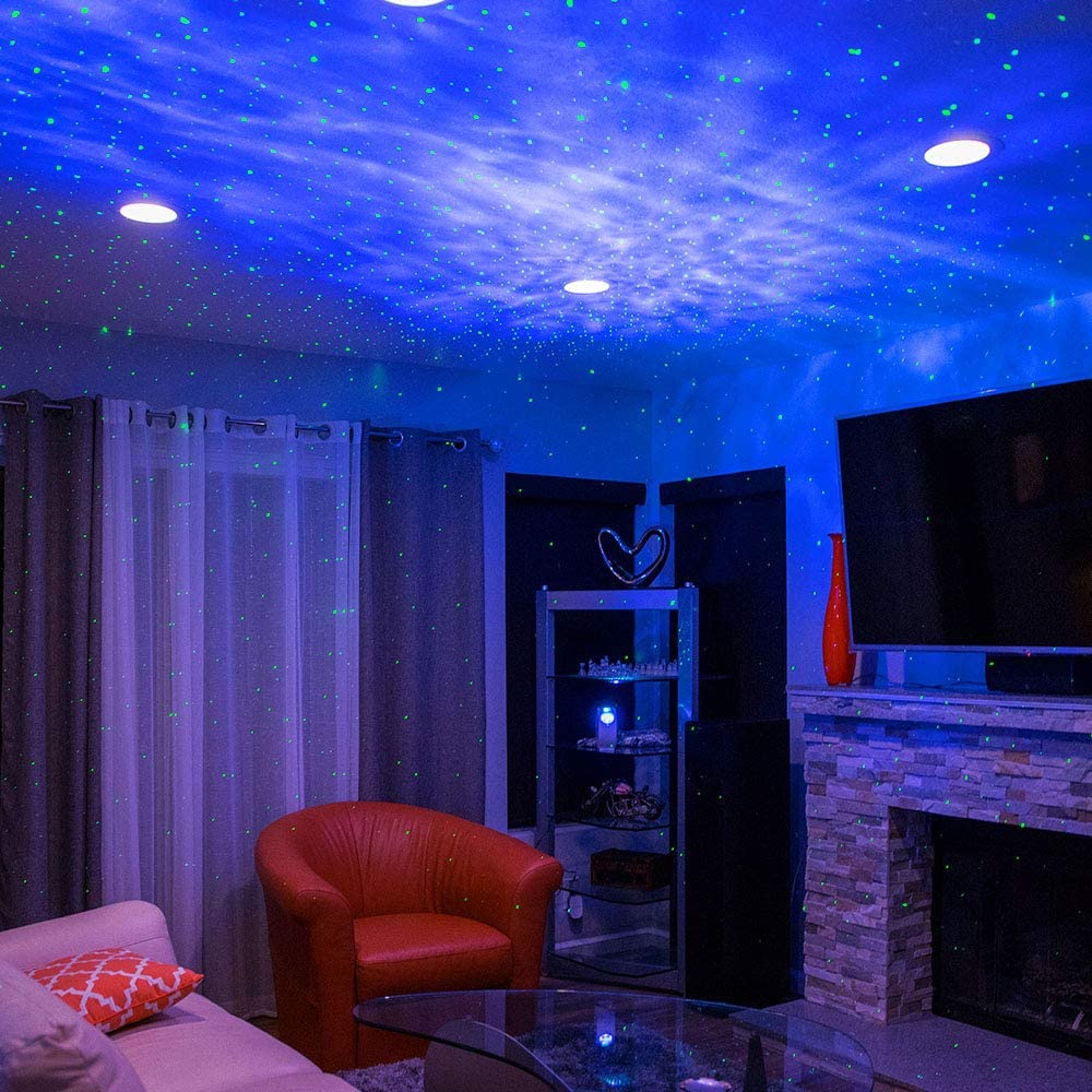 Living room with starry sky ceiling projection, red chair, and TV.