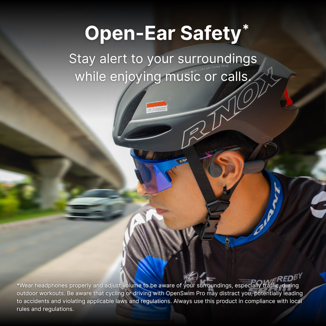 Person wearing open-ear bone conduction headphones on a road