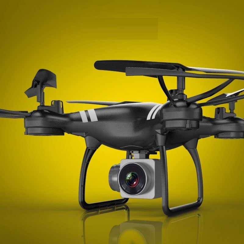 Black drone with a camera on a yellow background